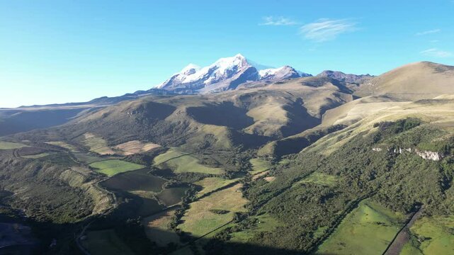 Cayambe volcano drone view with mountains and green flieds