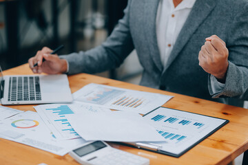 Young Businesspeople Working with Laptop in Modern Office. Office Workers at Work. Communication and Discussion at Work Concepts. Business Concept. Businessman and Businesswoman Concepts.