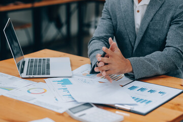 Young Businesspeople Working with Laptop in Modern Office. Office Workers at Work. Communication and Discussion at Work Concepts. Business Concept. Businessman and Businesswoman Concepts.