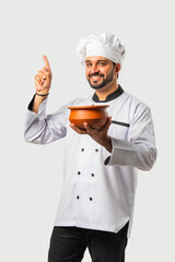Asian Indian male chef with biryani pot, isolated white background