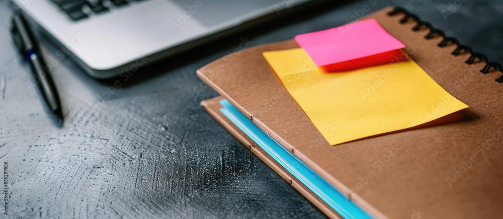 Poster a vibrant sticky note on a brown notebook against a white backdrop offers ample copy space for addin