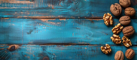 Blue wooden table with walnuts, providing a copy space image.