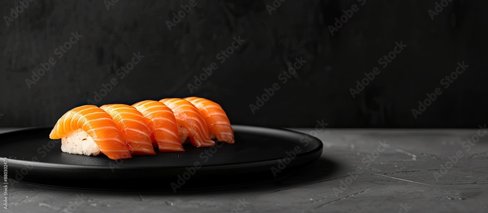 Poster salmon temaki sushi displayed on a black plate against a black background, with empty space for addi