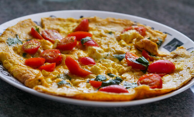 an omelet with cherry tomatoes