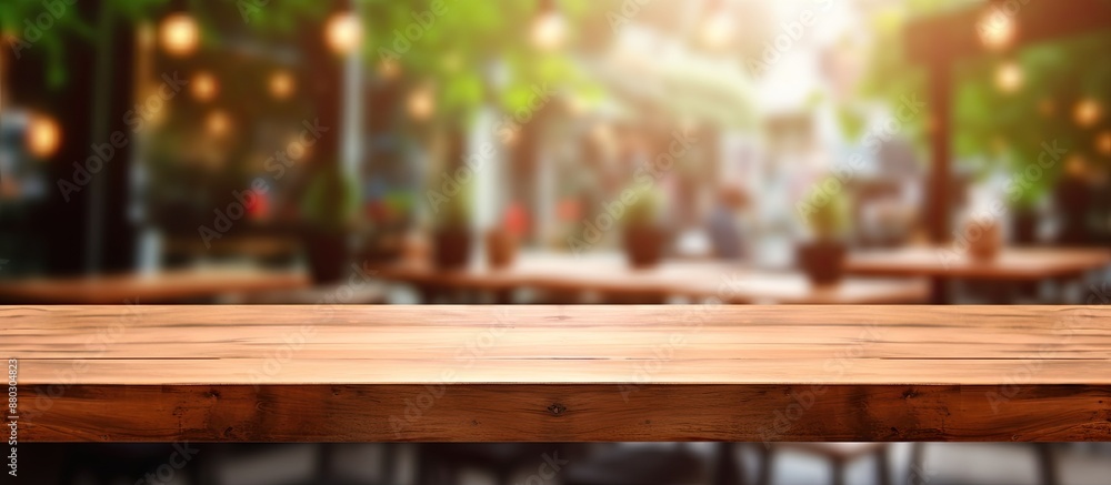 Poster the central focus is an empty brown wooden table set against a blurred coffee shop background with b