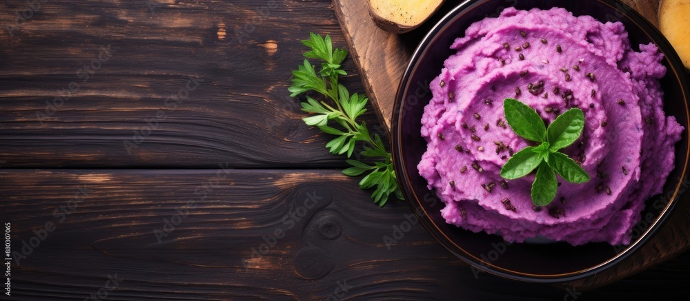 Poster top view of a dish with purple sweet potatoes and mashed potatoes on a wooden table, ideal for text 