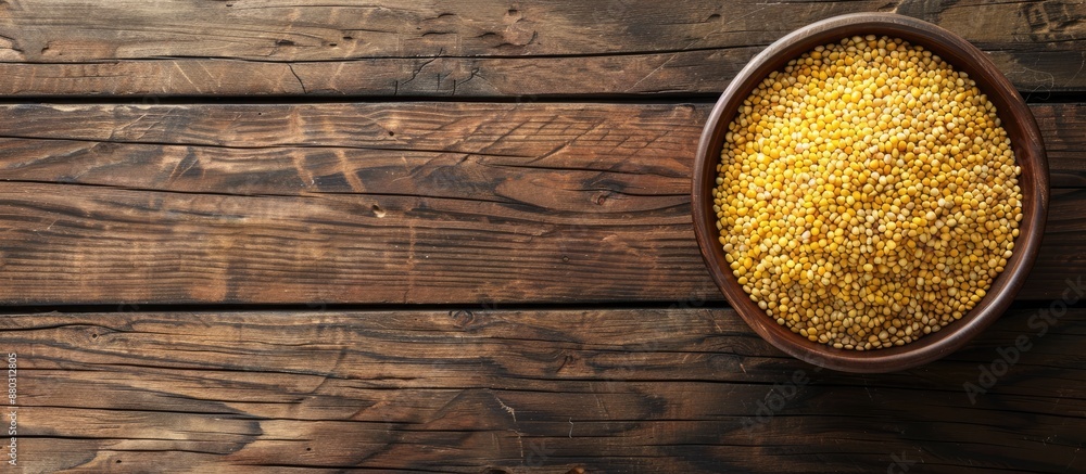 Aufkleber top view of a wooden table with a bowl of raw bulgur, providing a clear space for text in the image.