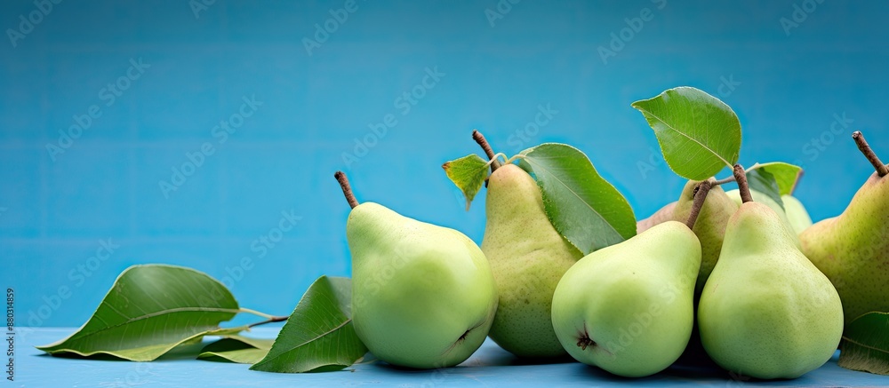 Poster fresh pears and leaves are set against a blue backdrop, ideal for a 
