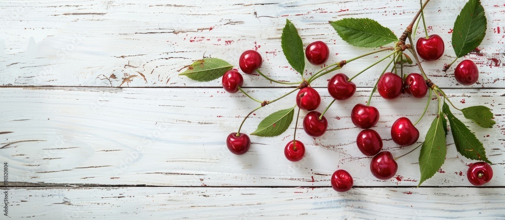 Sticker sour cherries with leaves set on a white wooden table, ideal for photography with copy space image i