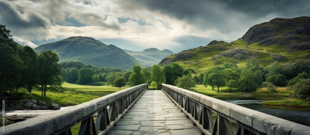 Poster a path leads to a gray granite bridge over a river with metal railings under a sky filled with cloud