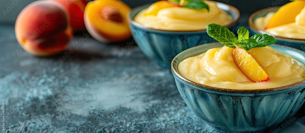 Aufkleber close-up of vanilla pudding and peaches in bowls on a textured grunge background, with copy space im