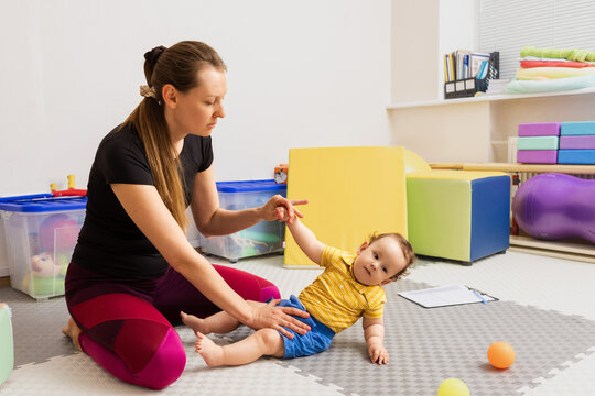 Hammersmith Infant neurological examination. Specialist testing little baby for presence of reflexes and assessed health using Hammersmith test
