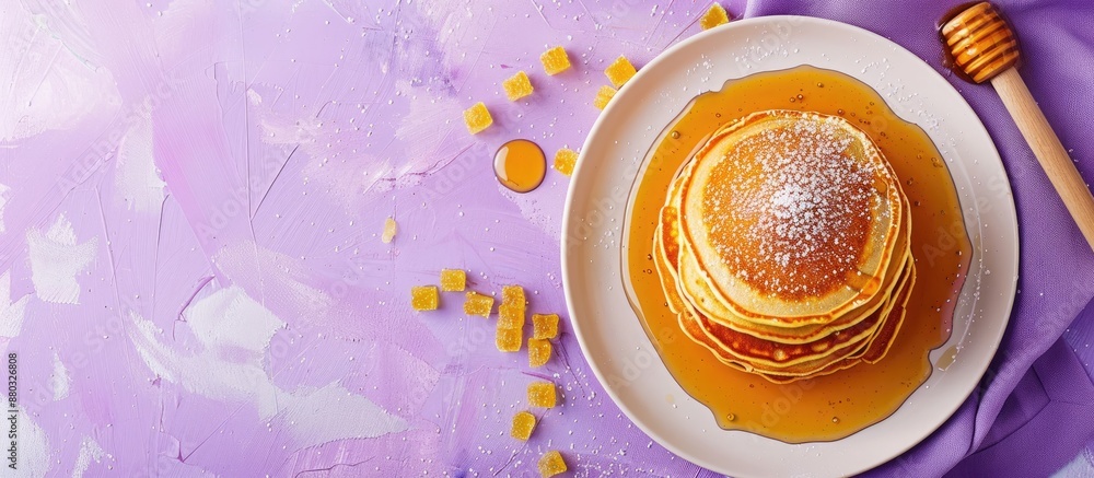 Aufkleber Top-down view of pancakes with honey and sweets presented on a purple backdrop with a blank area ideal for adding text or graphics - copy space image.