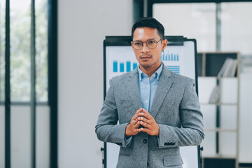 Fototapeta premium Young businessman giving presentation to his colleagues