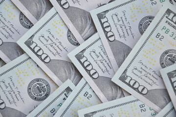 Processed collage of many US hundred dollar bills banknotes texture. Background for banner