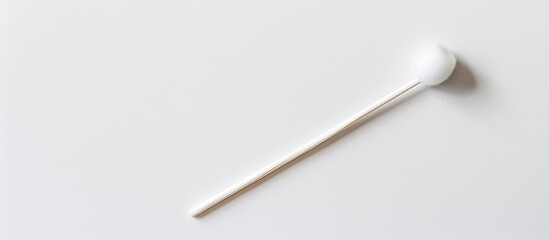 A cotton bud is shown on a white background for removing ear wax providing room for text with a copy space image