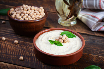 Eggplant hummus in a plate with basil. Chickpea dishes. Vegetarian food