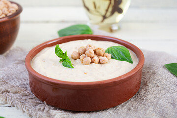 Eggplant hummus in a plate with basil. Chickpea dishes. Vegetarian food