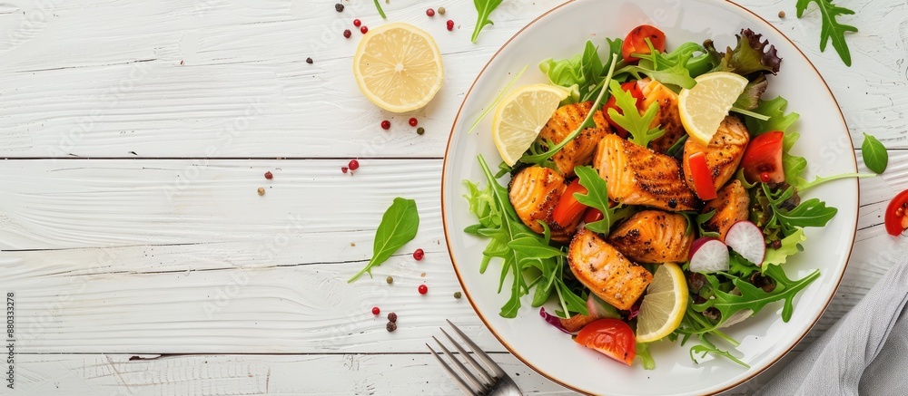 Aufkleber Salmon dish with salad and lemon garnish on a white wooden backdrop perfect for a copy space image