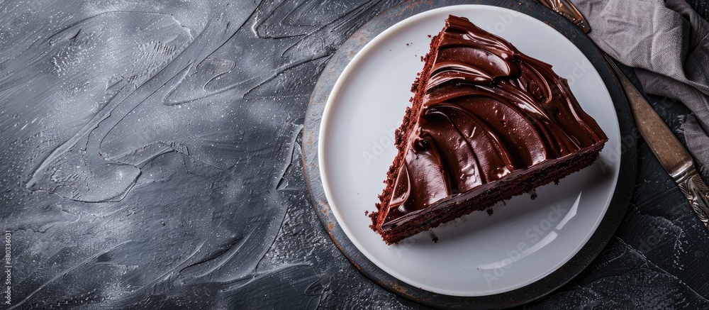 Poster chocolate cake concept rolling on a white plate providing a backdrop for copy space image