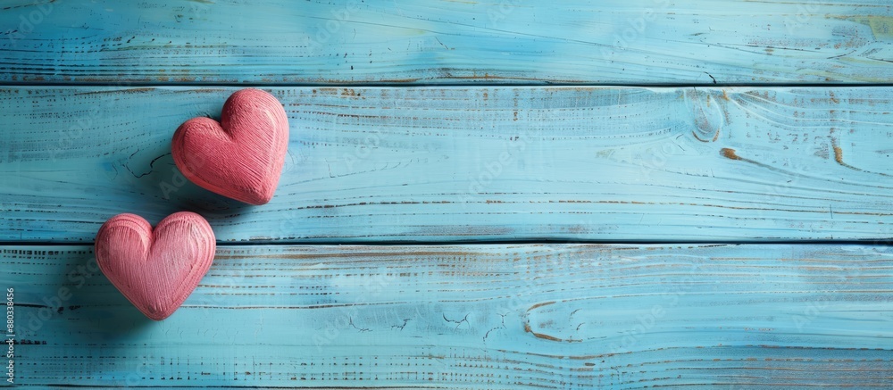 Poster blue wooden background with copy space image featuring two soft hearts for valentine s day theme
