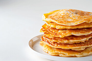 a stack of pancakes on a plate with a fork