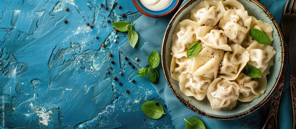 Poster top view of traditional russian dumplings and ravioli on a blue background with copy space image ava