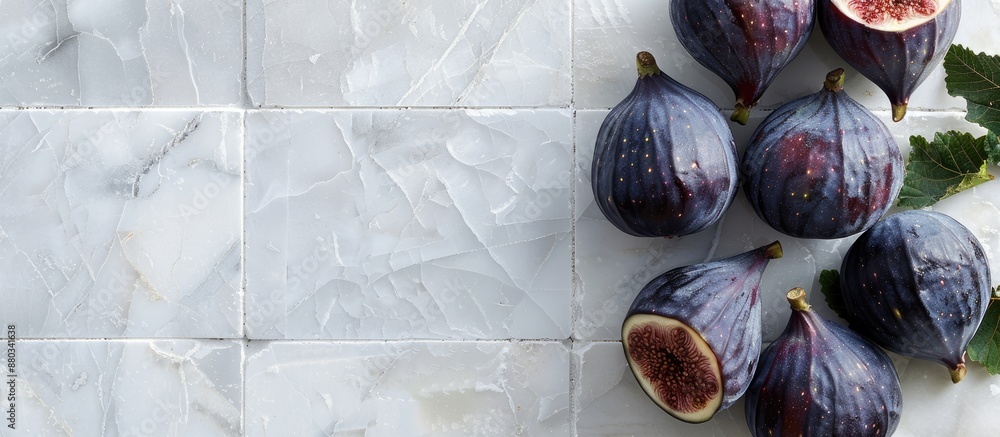 Poster flat lay of fresh ripe purple figs on a white tiled table with space for text in the image. with cop
