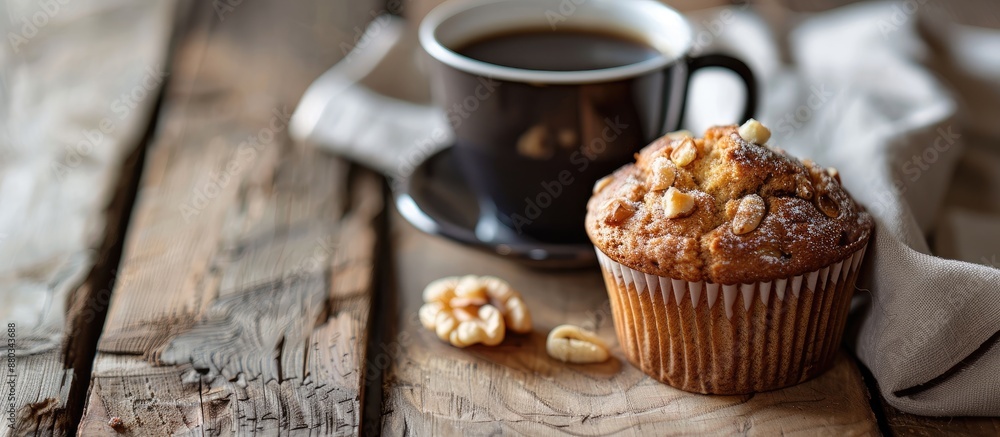 Poster Close up of a banana nut muffin served alongside coffee for breakfast on a vintage rustic wood kitchen table The image features selective focus and copy space
