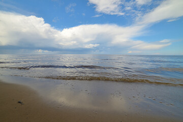 Picturesque beach with blue sky and fluffy white clouds