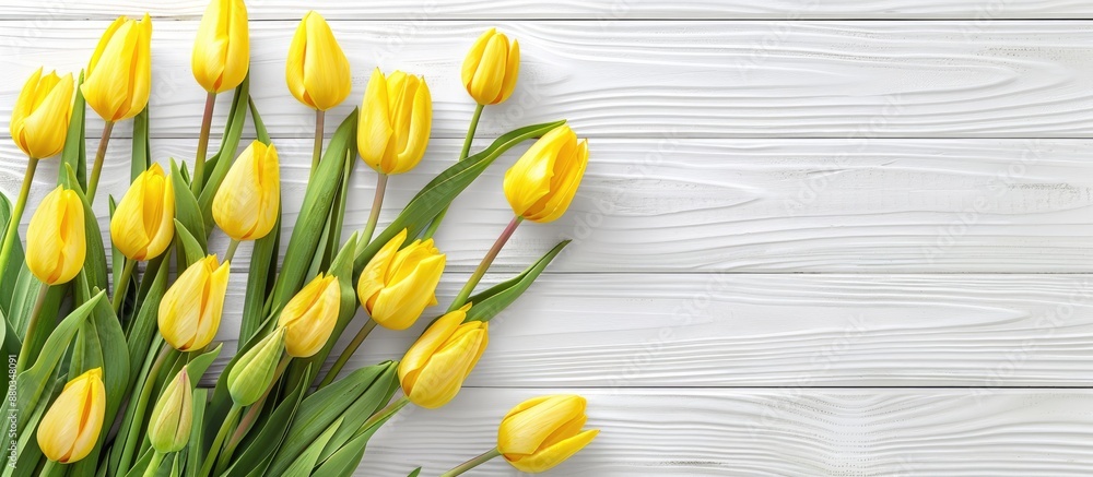 Aufkleber top view of yellow tulips on a white wooden surface providing ample copy space for text or image hig