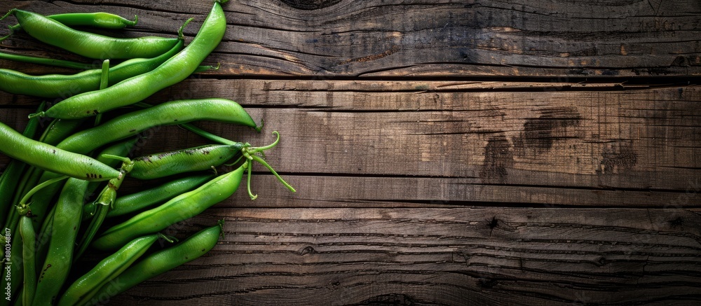 Poster wooden background showcasing fresh green beans with room for text or other elements in the image. wi