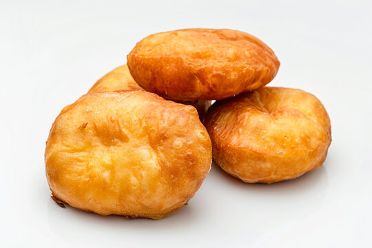 a pile of doughnuts sitting on top of a white surface