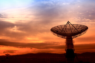 The silhouette of a radio telescope observatory