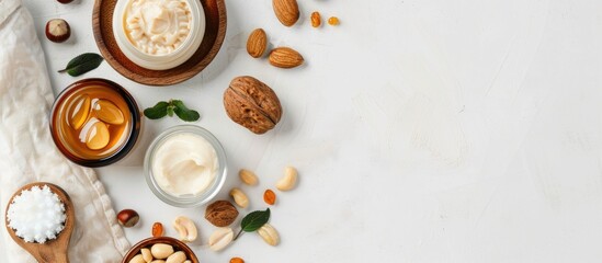 Argan and macadamia oil creme shampoo and nuts displayed on a white background with copy space image