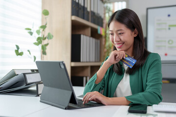 Asian businesswoman holding credit card, thinking, calculating loan amount Approval limit,...