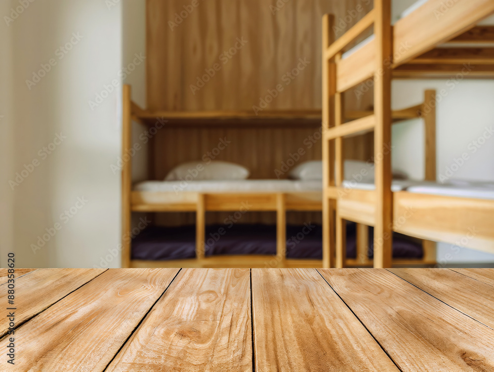 Poster Empty wooden table for displaying products with a blurred background of bunk beds