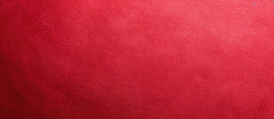 Fototapeta premium Vibrant red paper texture ideal for a design background with available copy space image