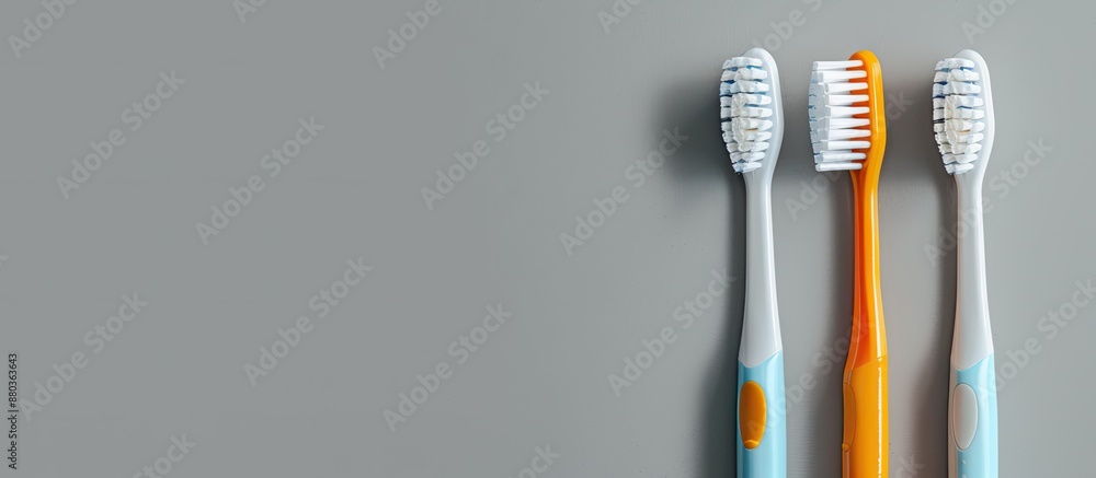 Poster toothbrushes both electric and plastic displayed on a grey background with copy space image