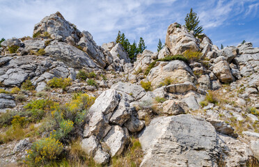 The Hoodoos at Silver Gate, A Mountain Road Winding Between White Boulders In Yellowstone National Park