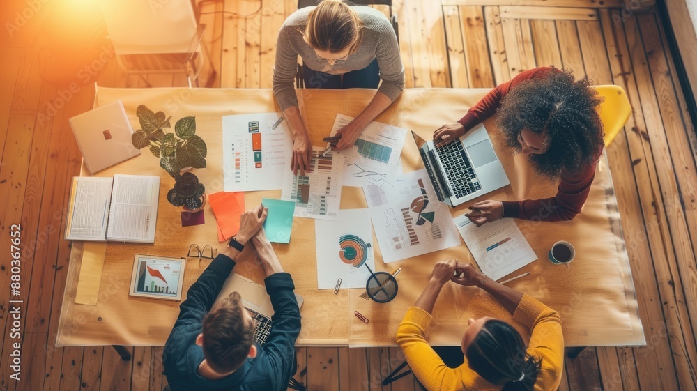 Poster a dynamic office scene featuring employees collaborating with laptops and colorful post-it notes on 