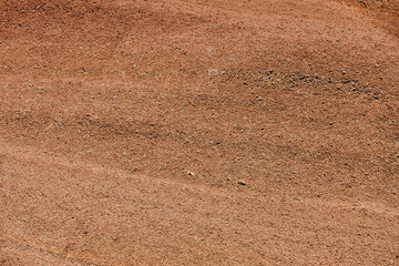 Red soil. Textured natural background. Mineral outdoor ground. Copy space