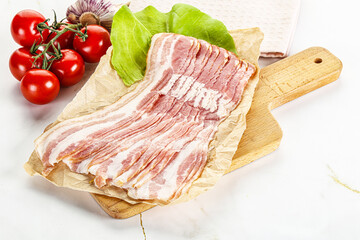 Sliced pork bacon oved board