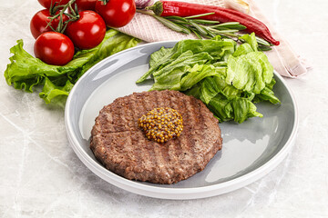 Frilled beef burger cutlet with iceberg