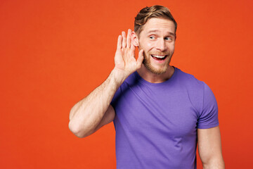 Young curious nosy smiling happy man he wear purple t-shirt casual clothes try to hear you overhear...