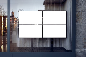 Four Widescreen TVs With White Screen Mockups For Banners And Branding. Empty Store Showcase With Blank Advertising Billboards