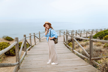 Young woman enjoying beautiful views and nature landscapes. Lifestyle, rest, vacation concept.