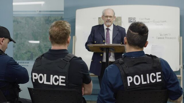 Chief briefing cops in conference room zoom out