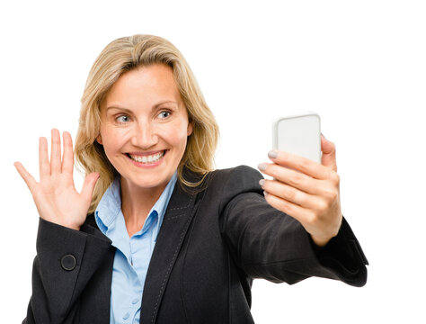 Business woman, video call and wave in studio with introduction, talk and contact by white background. Mature person, smartphone and happy with connection with hello, chat and icon with mobile app - Powered by Adobe