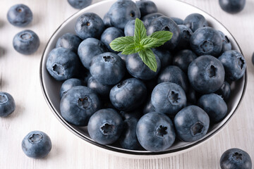 Fresh blueberries on a wooden white table